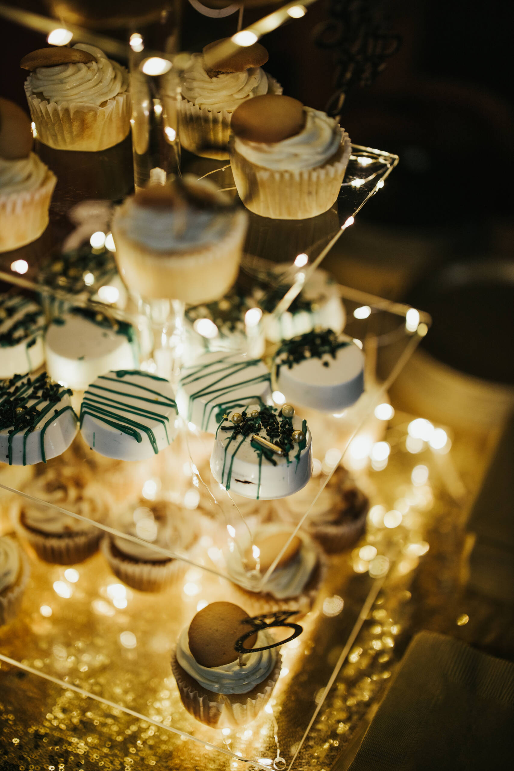 A vertical high angle shot of some cupcakes on a transparent plate